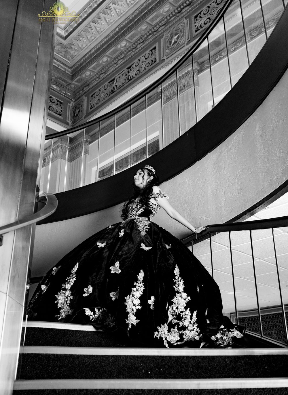Black and white architectural photograph showing curved balconies with ornate details in an elegant theater or opera house.