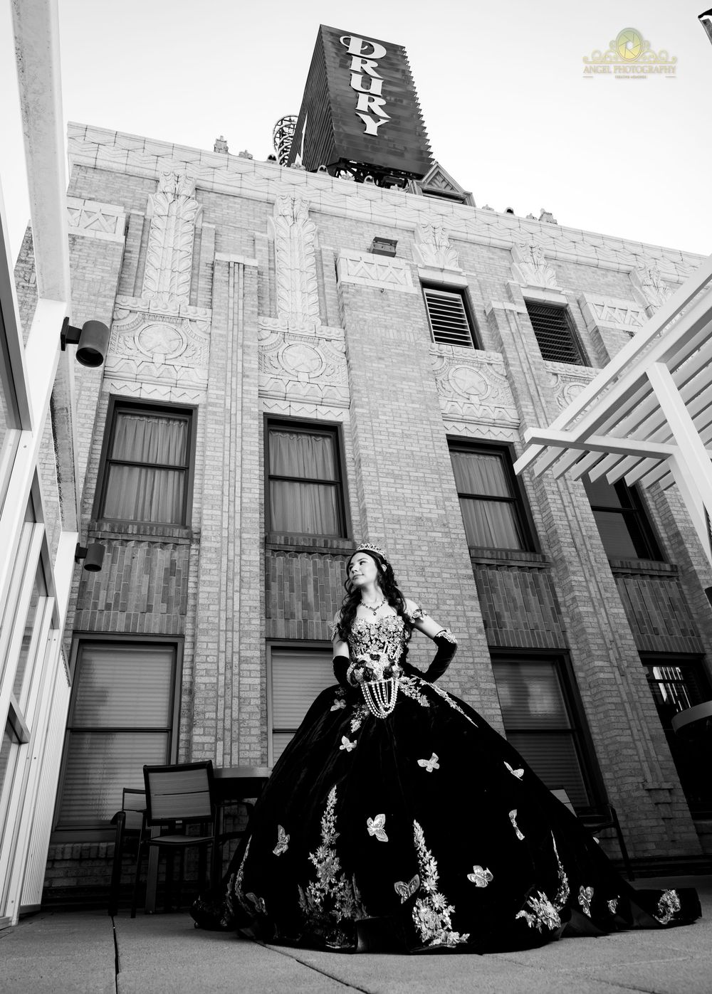 A dramatic black and white photo series featuring a flowing ball gown against an architectural backdrop.