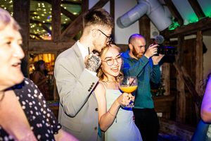 Couple sharing a romantic moment on the dance floor at an elegant wedding reception.