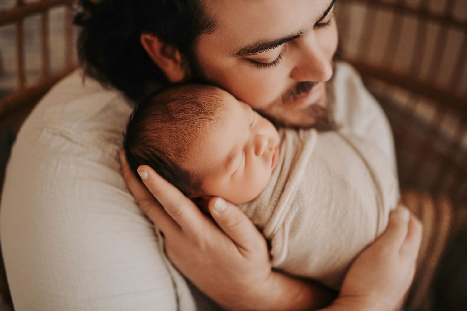 Father holding his newborn during a lifestyle newborn photography session