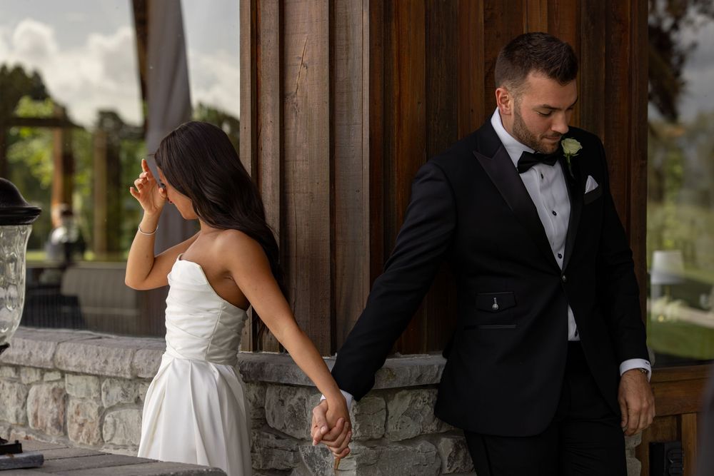 Sweet candid moments between bride and groom during wedding ceremony.