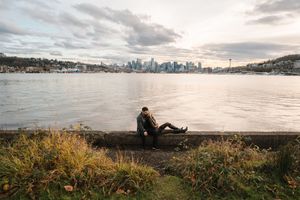 Panoramic view of Seattle skyline at sunset with Elliott Bay and West Seattle in the foreground.