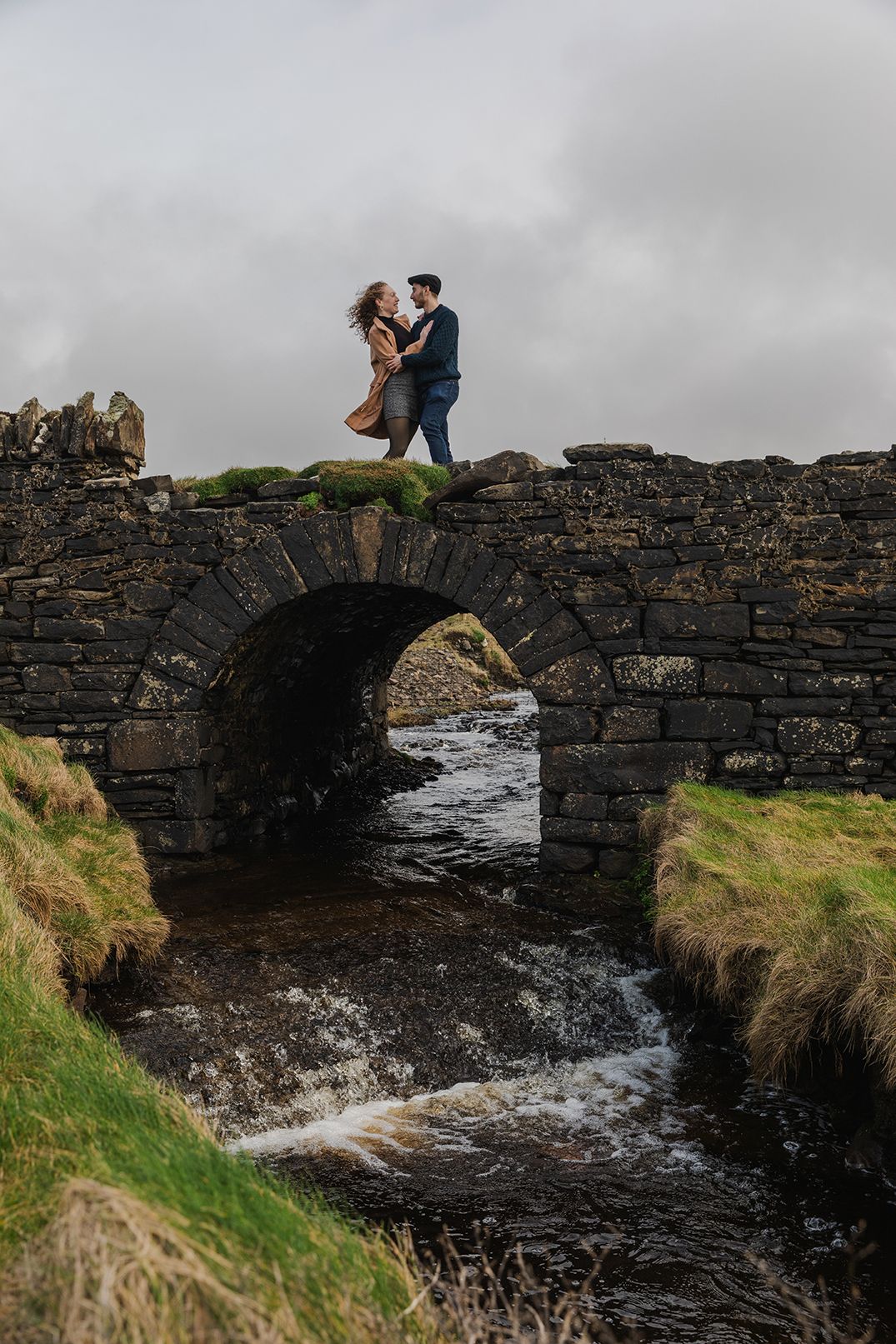 couple standing on the bridge on Doolin cliff walk