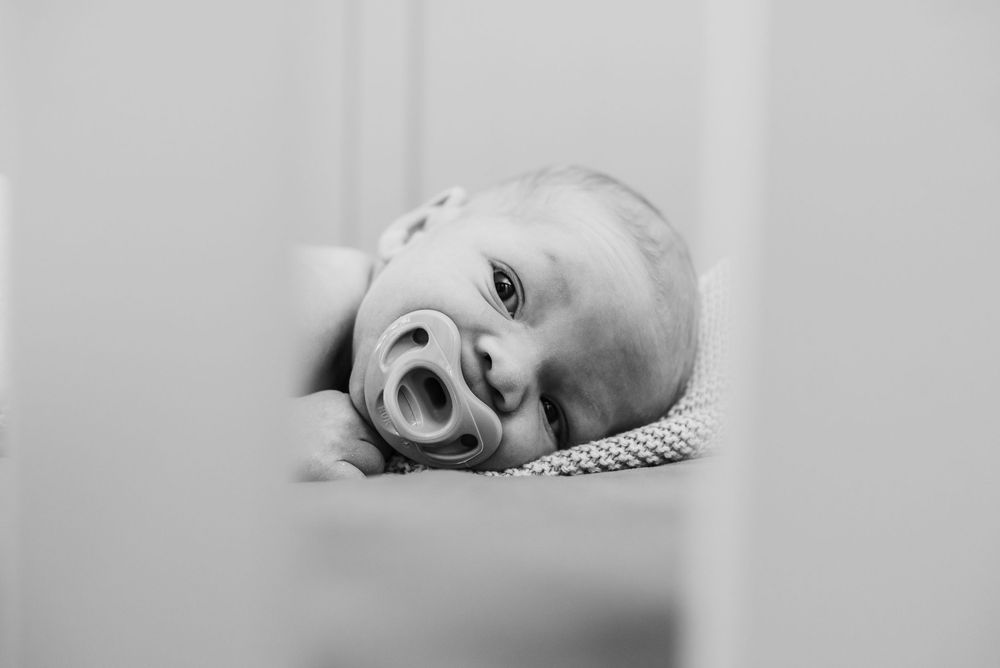 Black and white series of a sleeping baby in different peaceful resting positions.