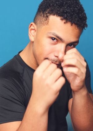 A person in a black shirt covers their face with both hands against a blue background in a sequence of photos.