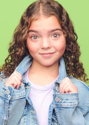 A series of four photos showing a child with curly hair wearing a denim jacket and white shirt making playful expressions.