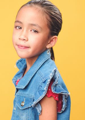 Young model wearing denim jacket poses playfully against bright yellow background in multiple shots.