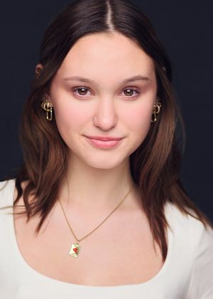 Portrait series against dark background showing different expressions while wearing white top.