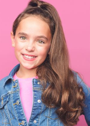 Young model wearing denim jacket against pink background showing playful expressions in series of headshots.