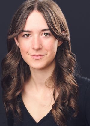 Studio headshots showing various poses against black background with wavy brown hair.