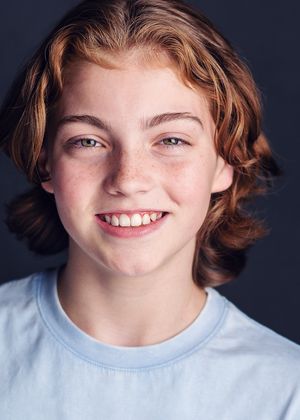 A series of five portrait photos showing a person with short wavy hair wearing a light blue shirt against a dark background.