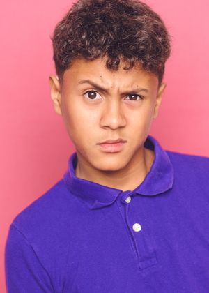 A series of headshots showing different expressions against a pink background while wearing a purple collared shirt.