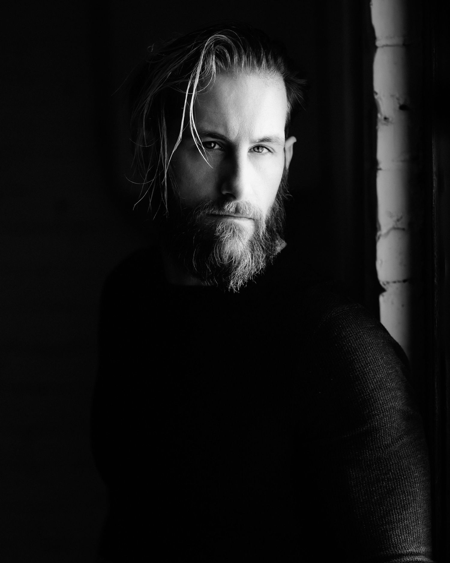 David G Holt Photography - Moody black and white portrait of bearded man in dark sweater.