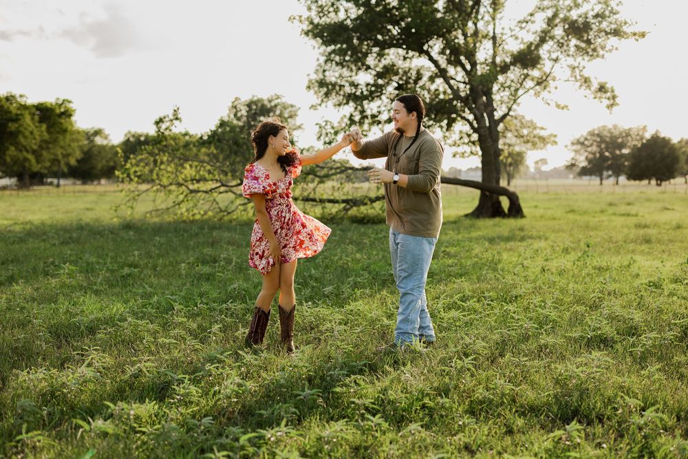 People enjoying a sunny afternoon in a grassy field with trees.
