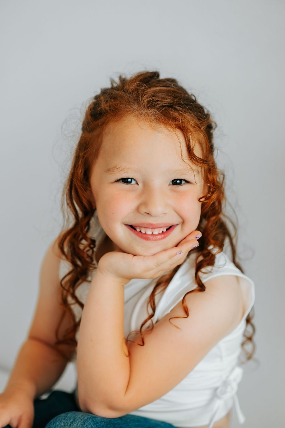 Close-up shots showing playful expressions against a light gray background.