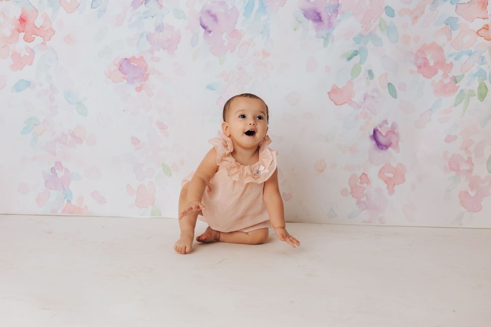 Professional studio photo setup with floral backdrop and soft lighting.