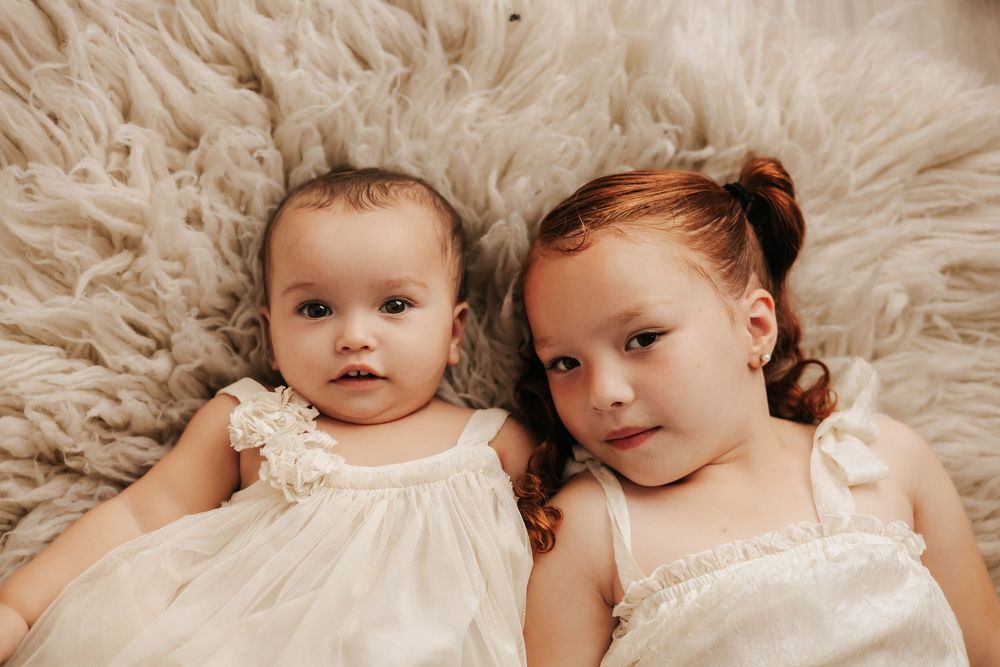 Studio portrait on plush cream colored fur backdrop.