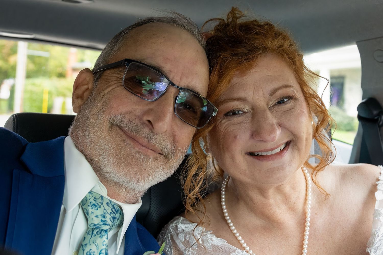 Frederick Maryland Wedding Photographer   A couple shares a joyful moment together in the back seat of a car.
