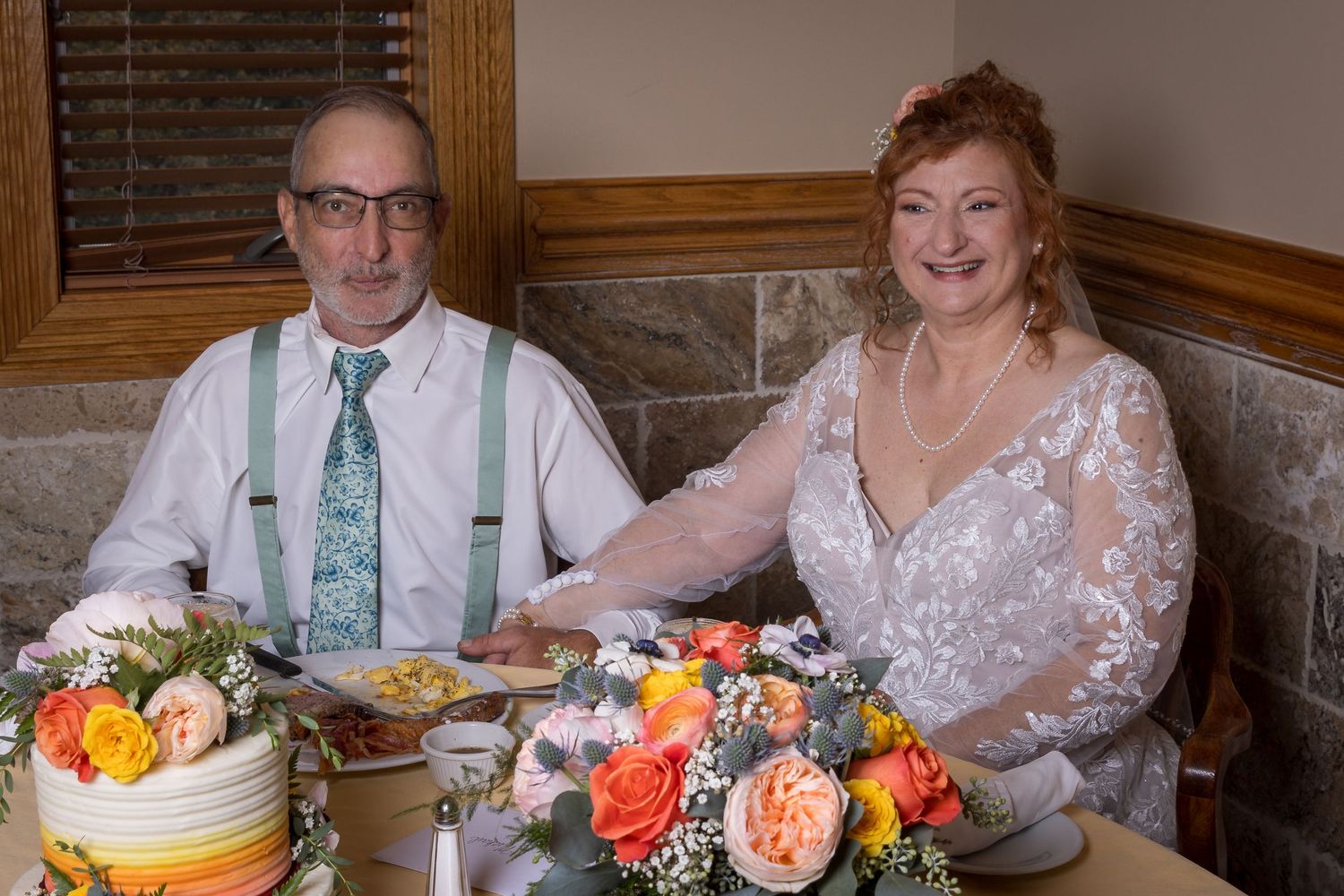 Frederick Maryland Wedding Photographer   A wedding celebration with floral centerpieces and a decorated cake on the table.