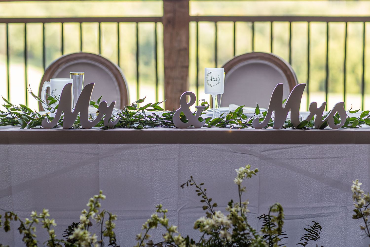 frederick maryland wedding Elegant wedding reception table settings with glowing string lights and greenery creating a romantic ambiance.