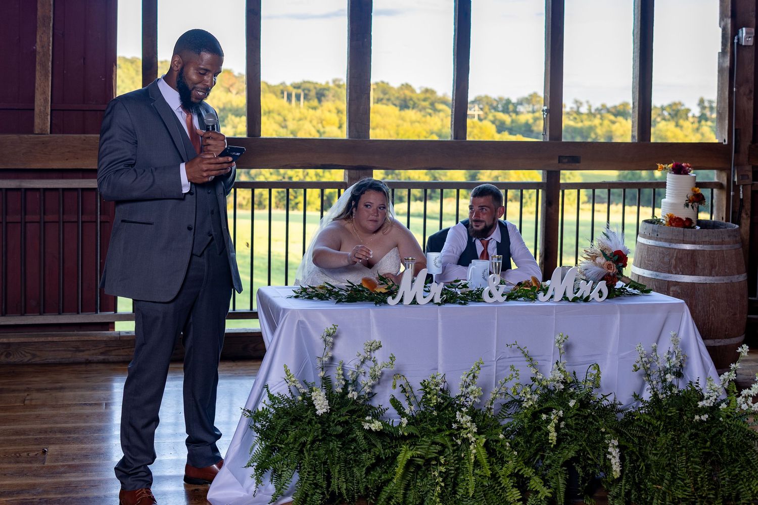 frederick maryland wedding photographer Indoor wedding reception venue with large windows overlooking scenic grounds.