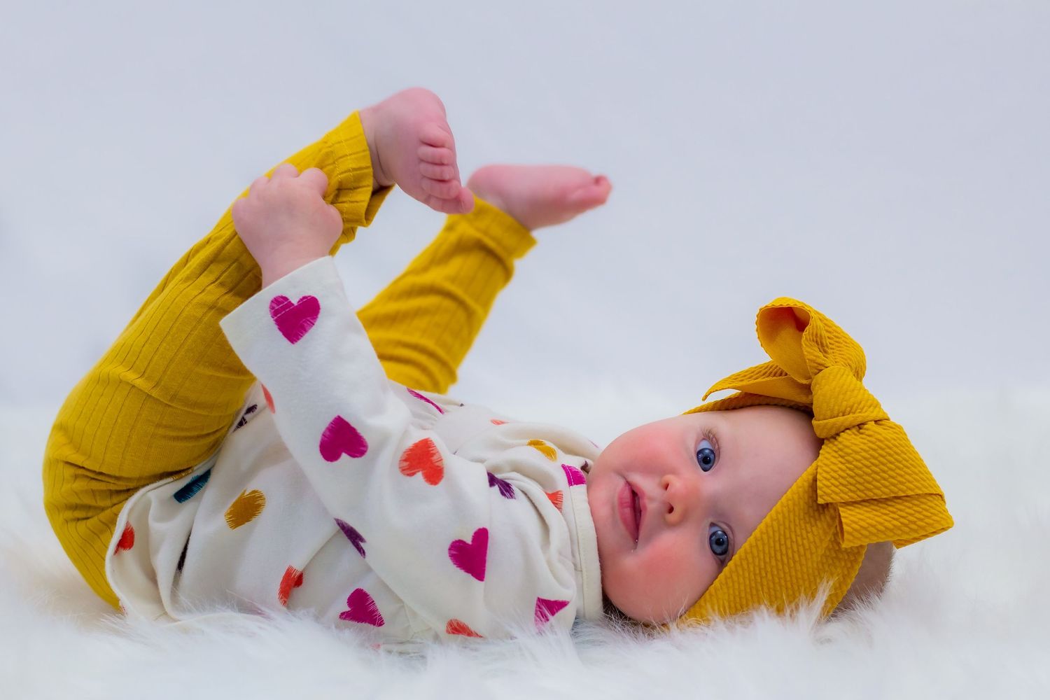 Six month old smiling sweetly during their milestone photography session in Wausau, Wi