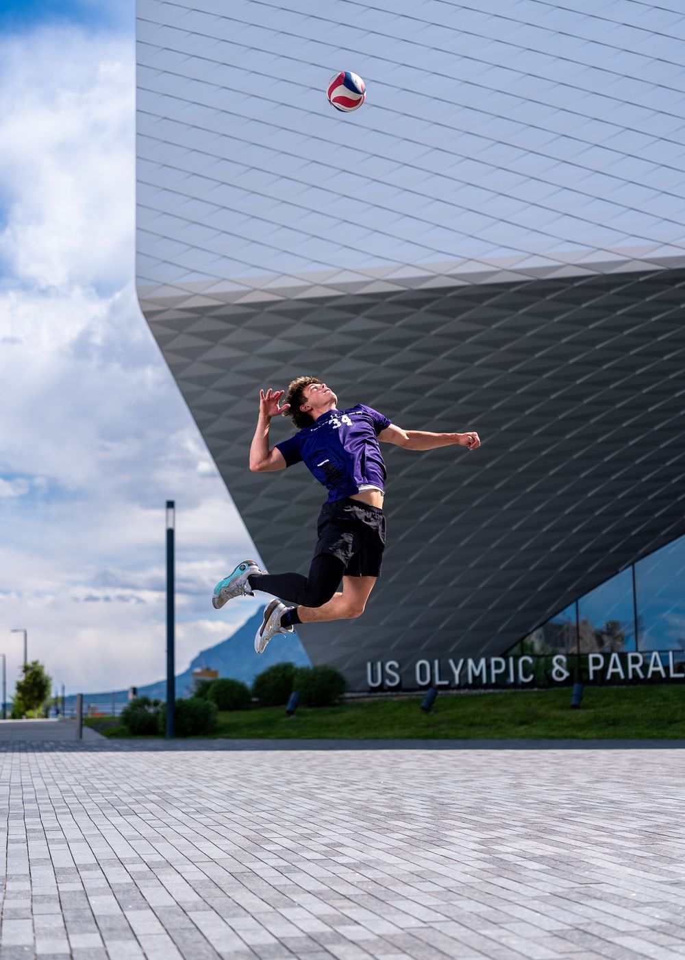 A volleyball player jumps to spike a ball outside the US Olympic & Paralympic Museum in Colorado Springs.
