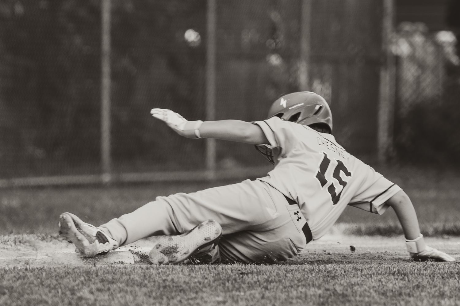 Vintage black and white baseball photographs showing players sliding into bases during gameplay.