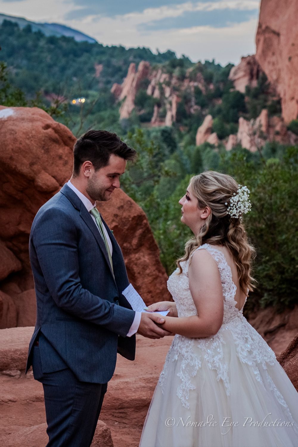 A wedding couple exchanges vows at Garden of the Gods with red rocks in the background.