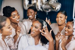 Wedding party getting ready together in a bridal suite sharing joyful moments.