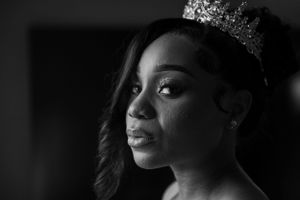 A dramatic black and white portrait showcases elegant bridal makeup and crown.