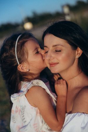A tender moment captured between parent and child during sunset.