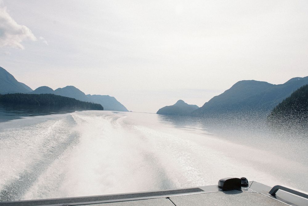 Aerial view of mountains and water creating a serene coastal landscape.