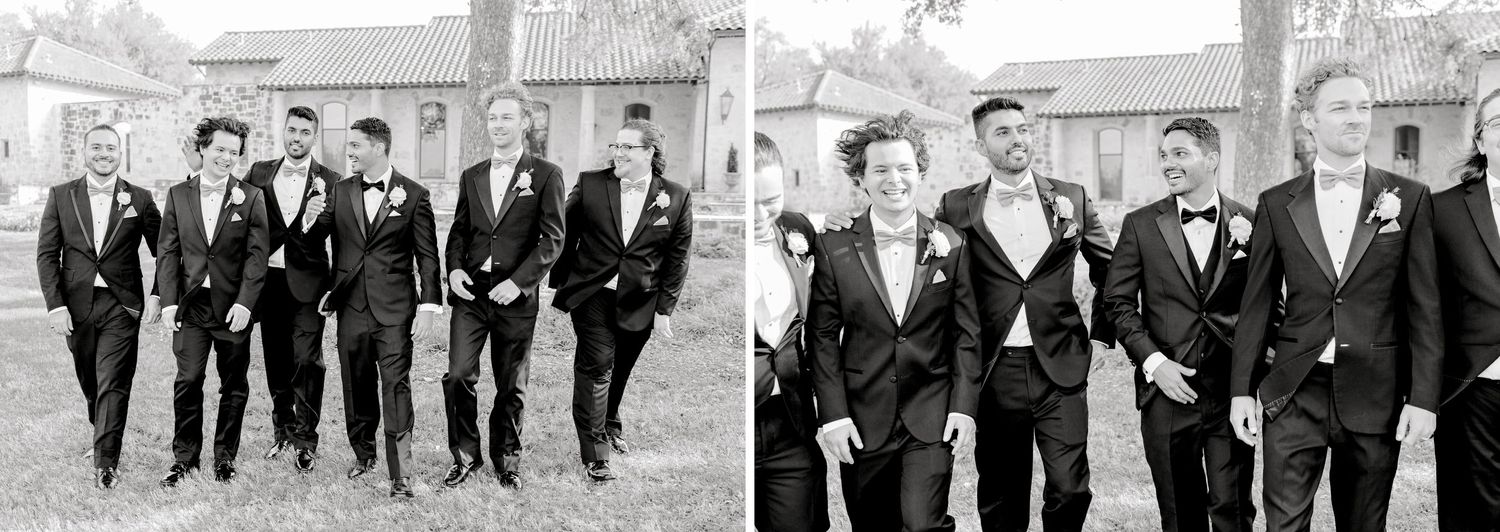 Groomsmen walking together and laughing outdoors in black tuxedos at a wedding celebration.