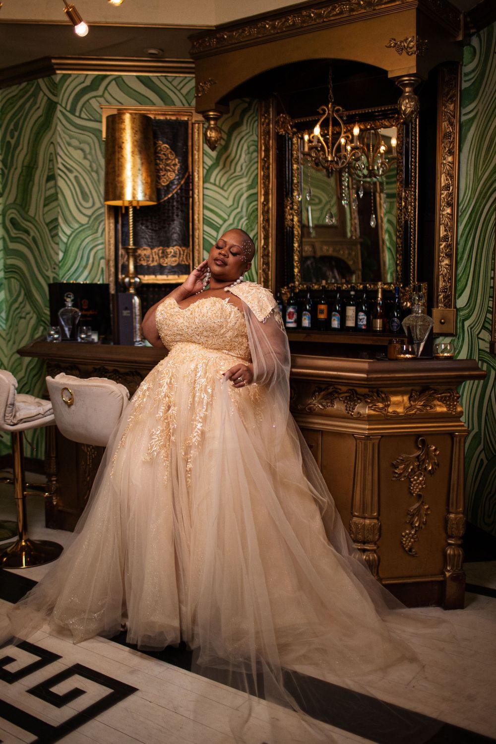 Stunning champagne tulle ballgown in an opulent green and gold bar setting.