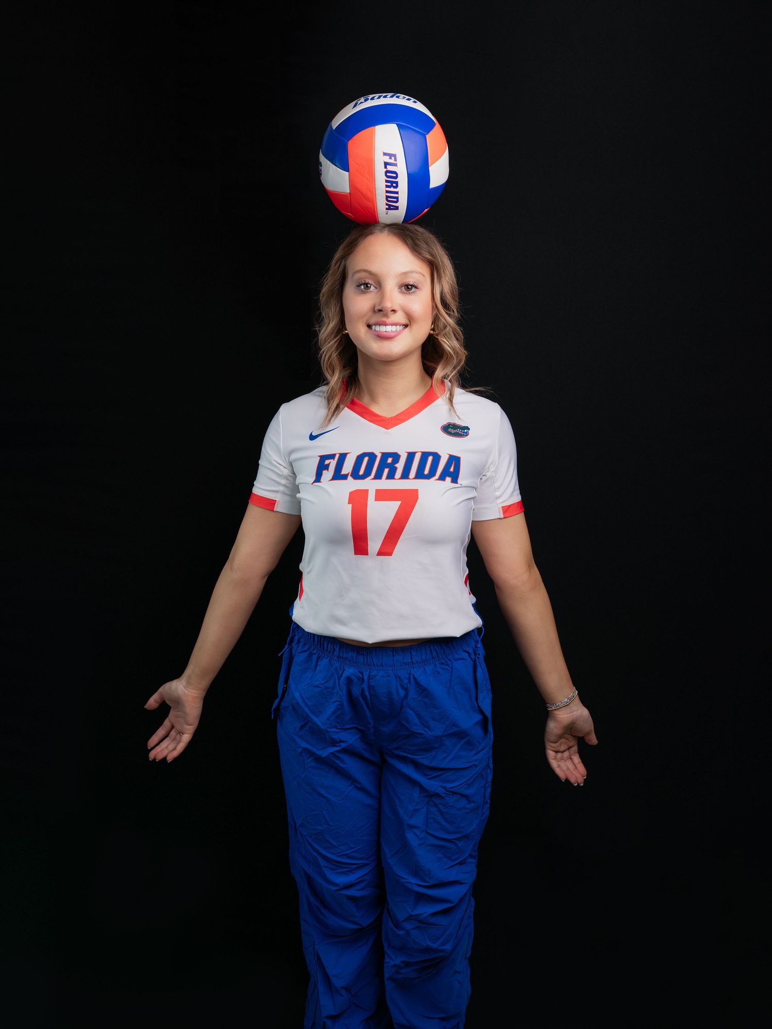 Photo of high school senior in a Gators volleyball uniform with a ball on her head taken by East Tennessee sports photographer