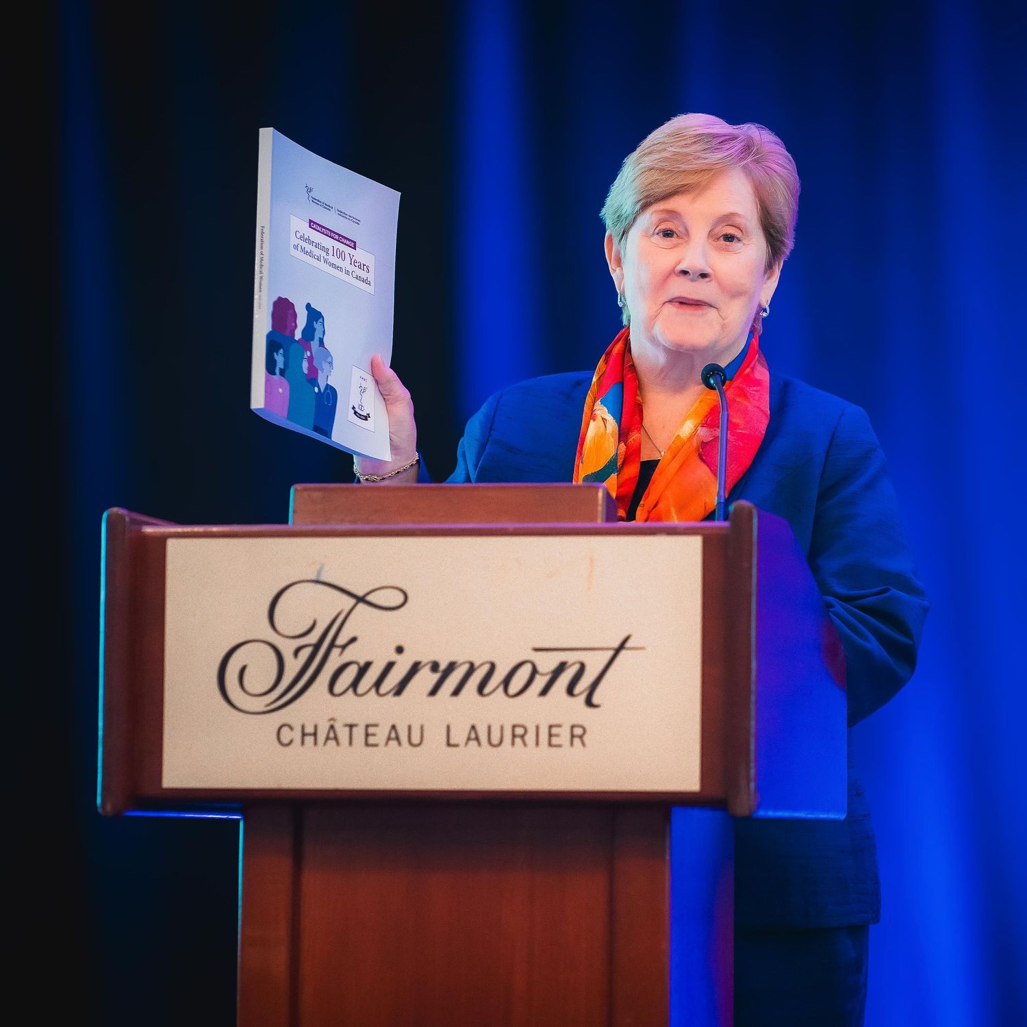 The image from Ottawa's Chateau Laurier event where a speaker is addressing the