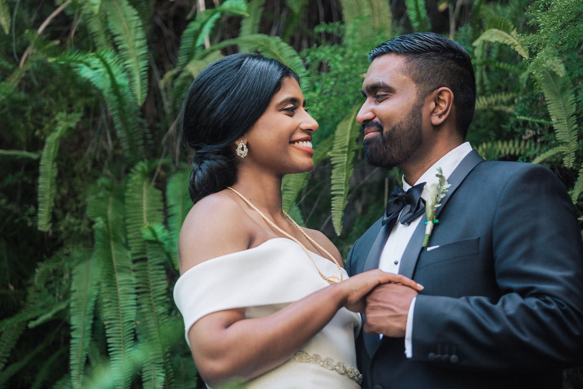 indian couple at estufa fria venue, bride in white and groom in tuxedo, photographed by a destination wedding photographer in Portugal