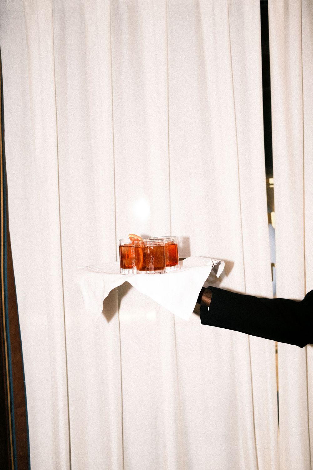 Elegant drink detail at a branded cocktail hour at an international business event in Milan.