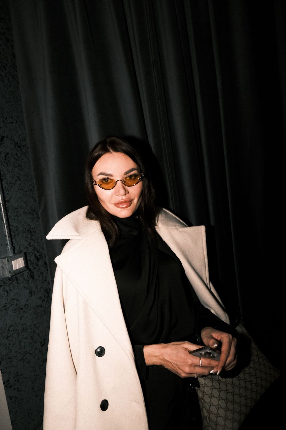 High-fashion inspired portrait of a businesswoman at a luxury corporate retreat in northern Italy.
