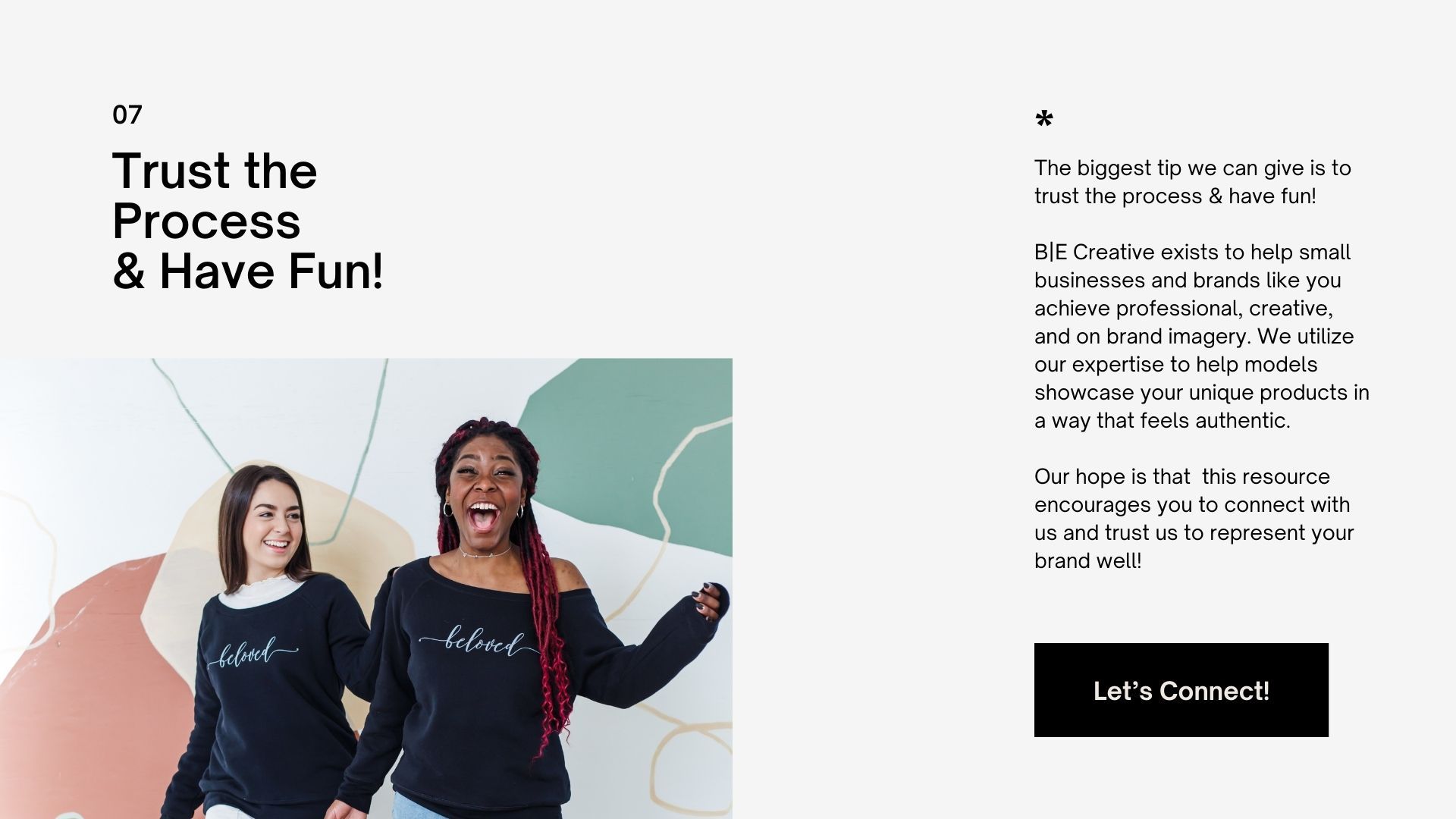 Two people in casual sweatshirts smiling in front of a minimalist background with shapes and text about trusting the process.