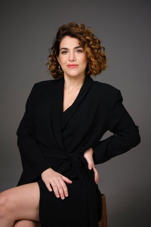 Modern glamour portrait with dramatic lighting and sophisticated black wardrobe.