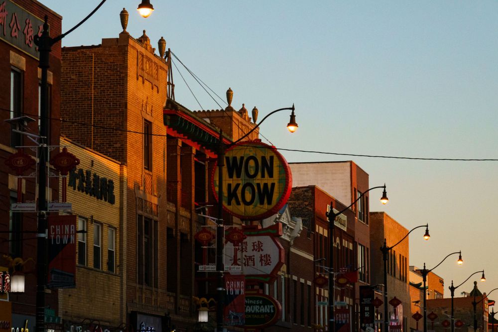 Brick storefronts on main street lit by golden sunset light.