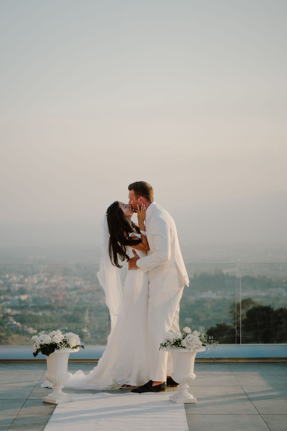 Newlyweds giving a kiss right after their wedding ceremony in Italy