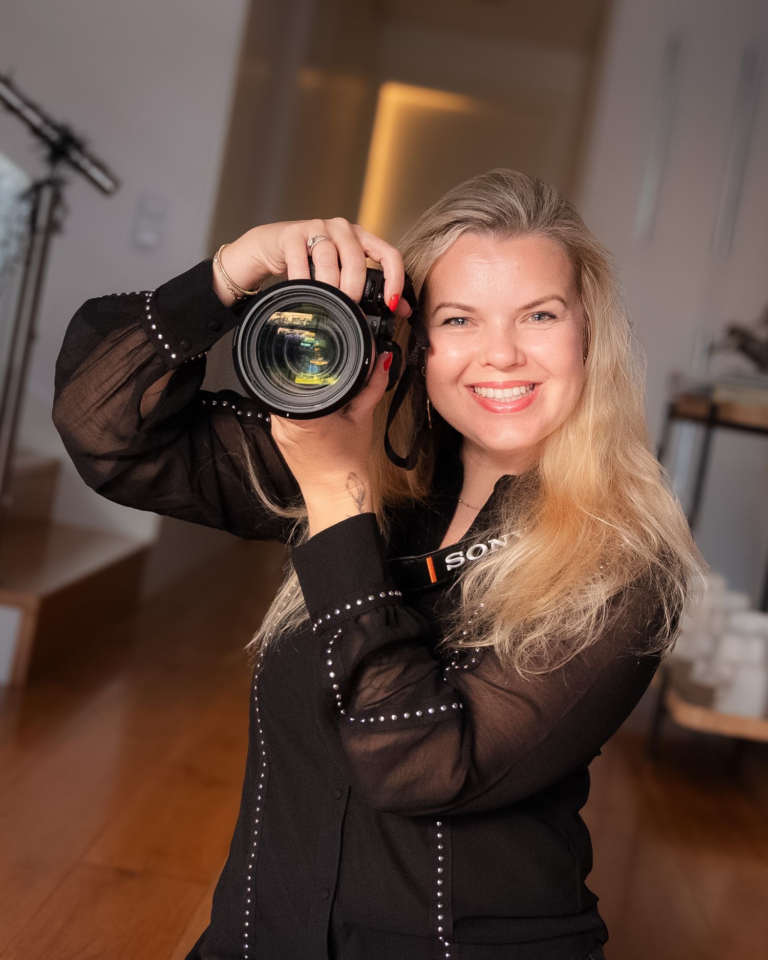 Beautiful talented woman photographer posing with her camera