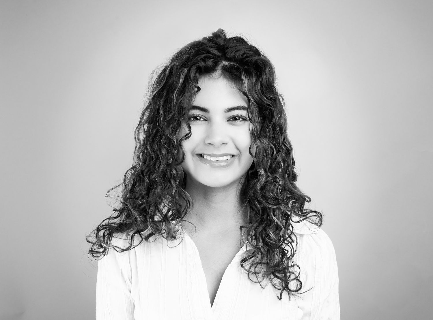 Black and white landscape image of a girl smiling
