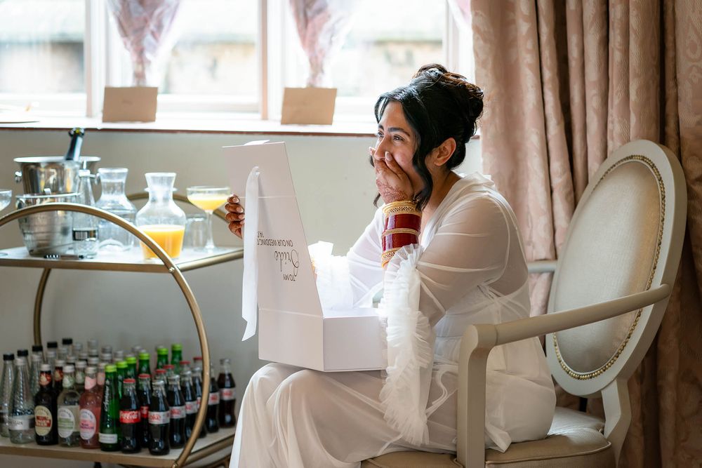 Bride receiving gift from Groom pre ceremony at St Audries Park Wedding venue in Somerset