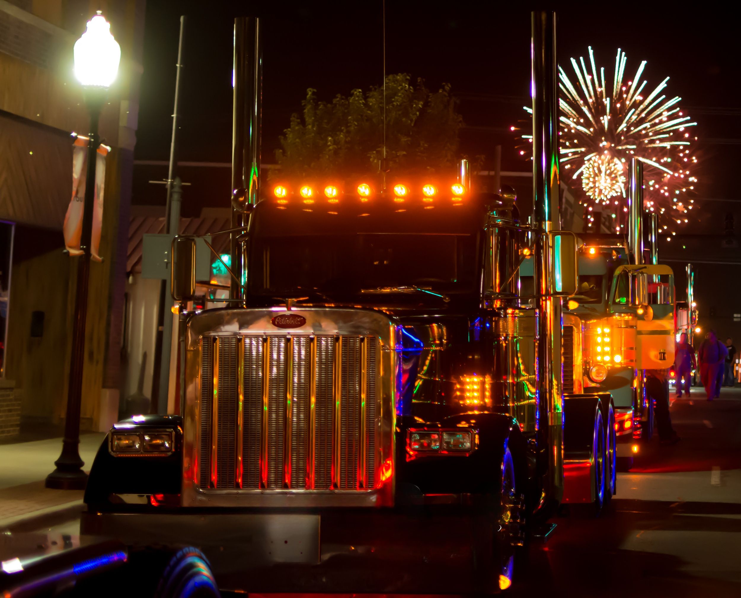Chrome Peterbilt show truck parade through downtown at night with fireworks Joplin, Missouri.