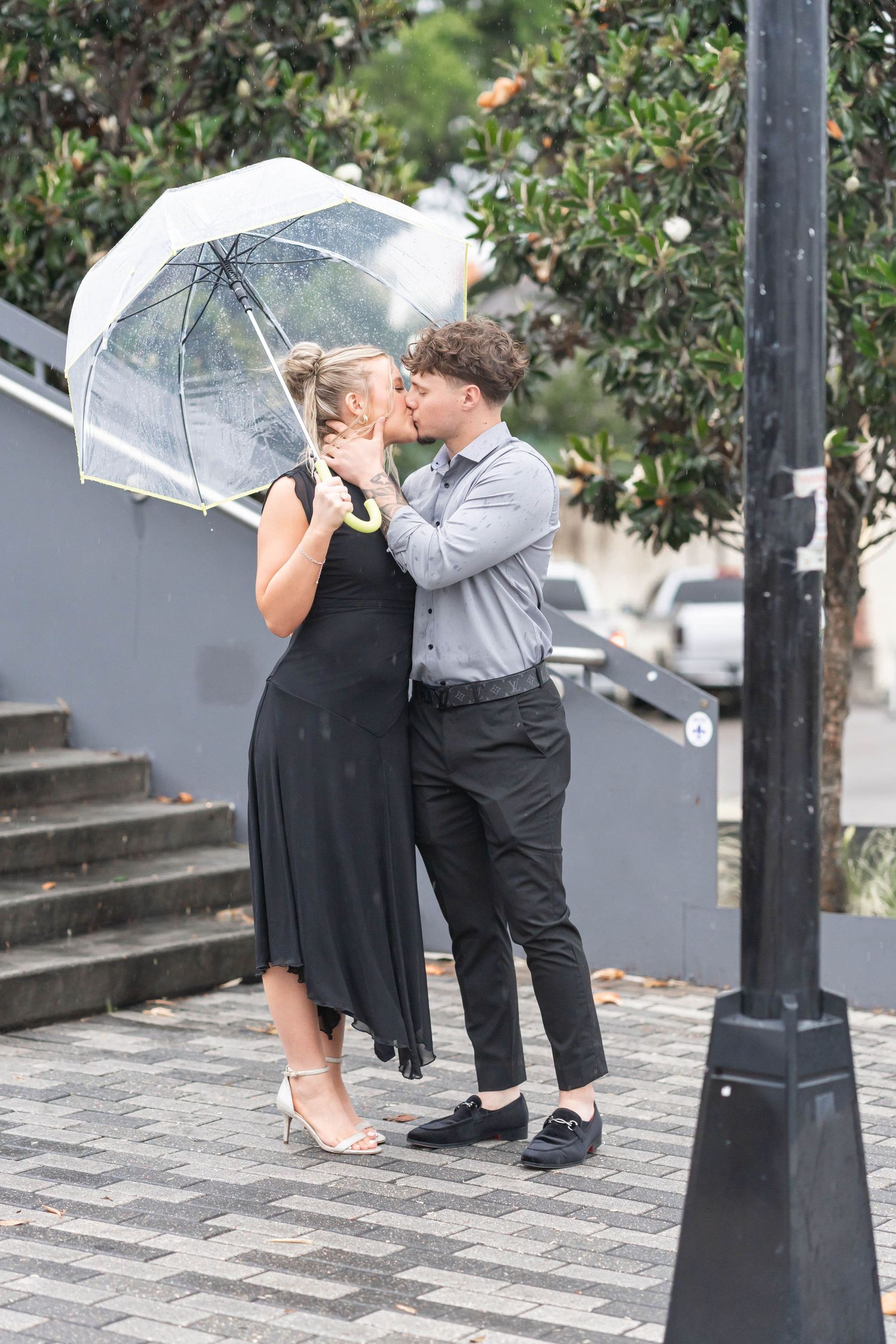 engaged couple kisses