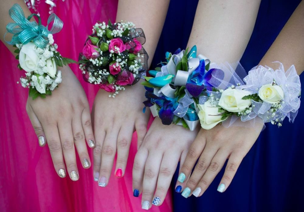 Four young women show off their corsages before the prom.